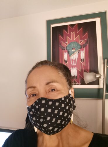 A photo of Kat Norris wearing a mask. 