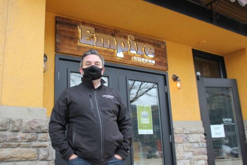 Man in mask infront of cafe