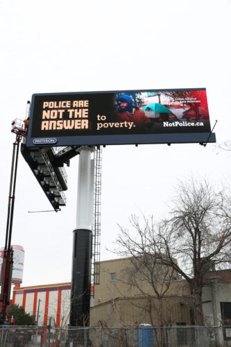 picture of billboard that says "police are not the answer to poverty"