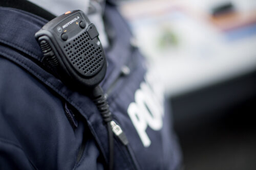 A close up photograph of the protective vest of a police officer.