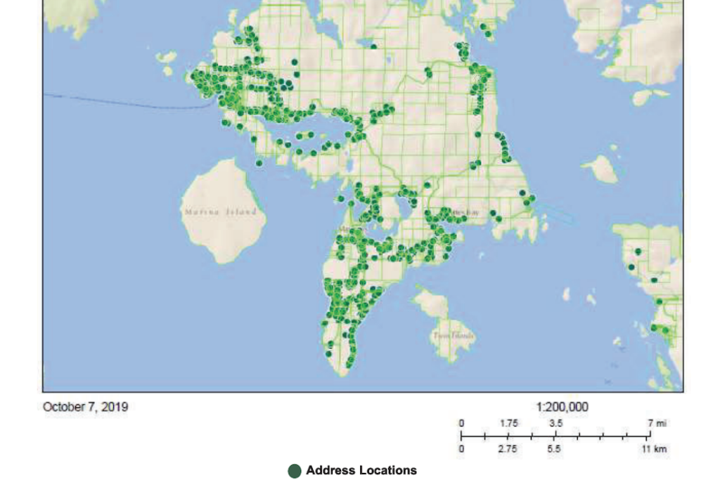 A map shows an island with green dots symbolizing households.