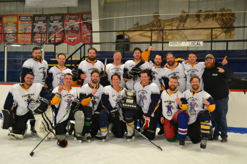 Farmers Mob, wearing white jerseys with a farmer logo, pose for a team picture on the ice after winning the B Division final.