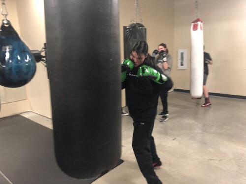 Image shows Maria Laboucane hitting a punching bag