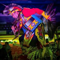 A dancer performing an Indigenous Mi'kmaq powwow dance on stage during last year's Canada Day festival.