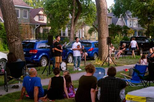 Image shows artist performing on curbside in Calgary