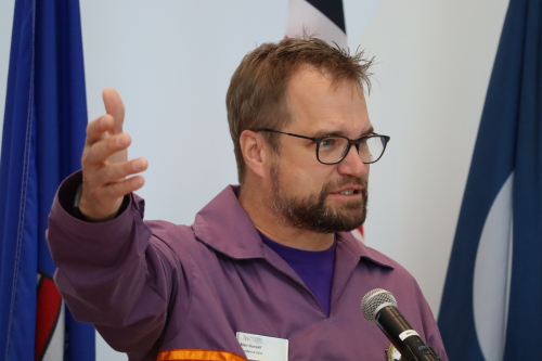 Image shows Allan Nursall speaking at mural ceremony