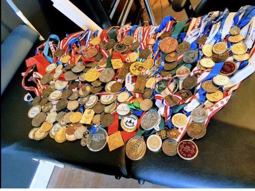 Photo of Phil Brown's 185 medals from competing in speed skating, powerlifting and soccer.