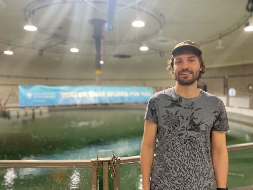 Photo of student Eric Reich who has been working on the Atlantic whitefish project and is currently doing his coop in the Aquatron.