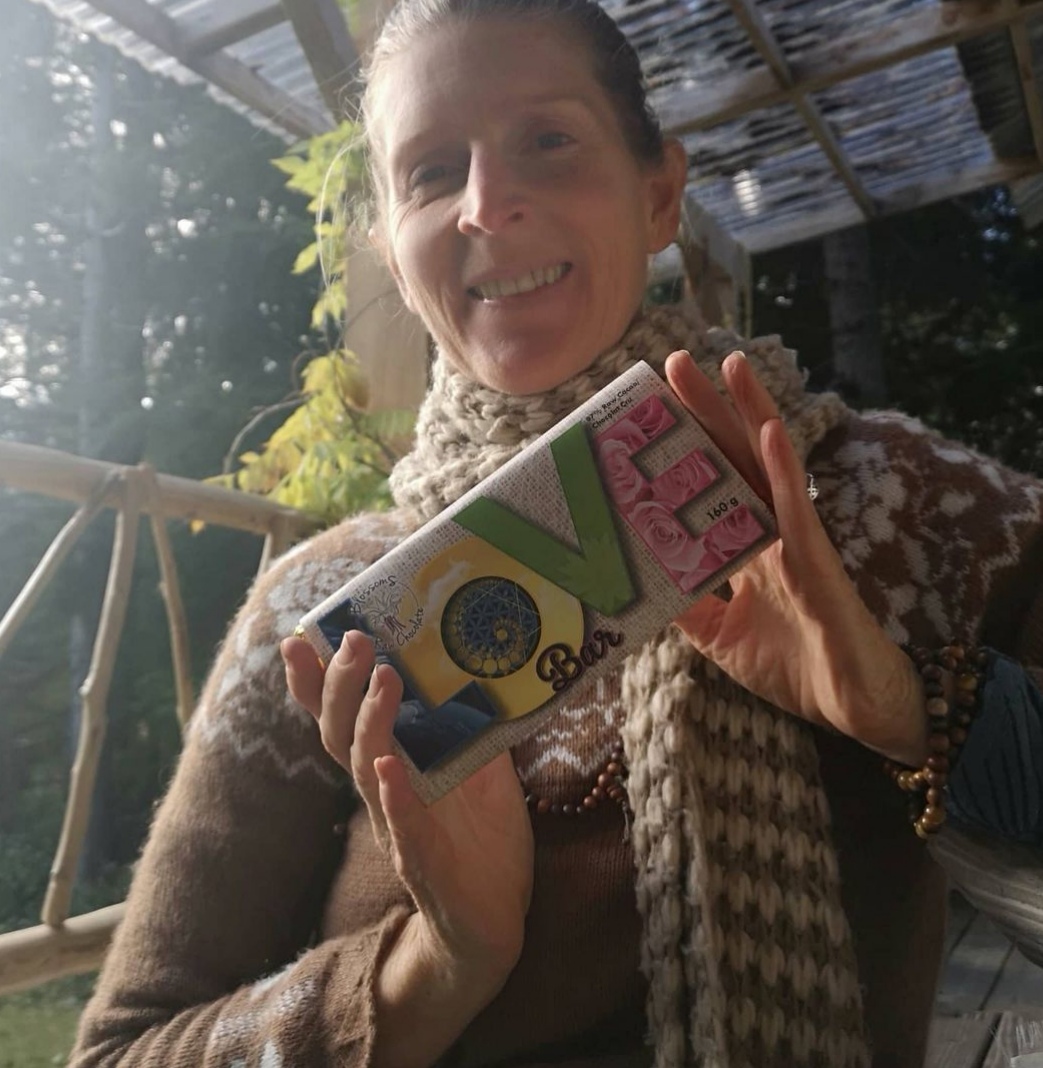 A woman holds up a large chocolate bar labeled, "LOVE".