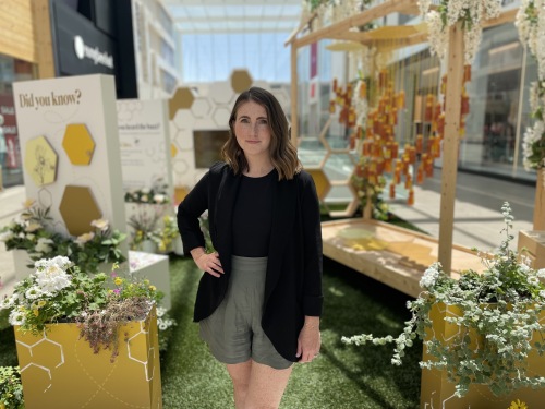 Stephanie Schnare standing in front of Halifax Shopping Centre's latest honeybee installation.