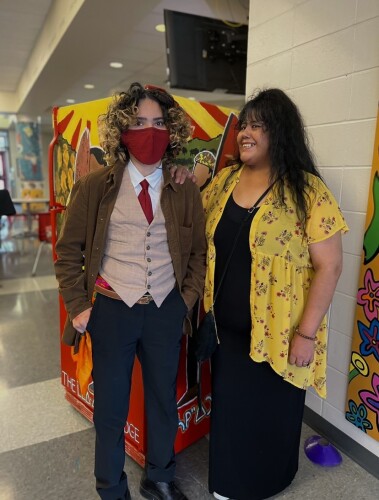 Stevie Lawerence standing with her grandmother Valerie Lawerence in front of the community fridge at the high school in Edmonton.