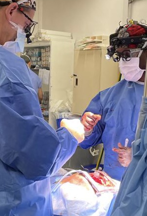 Photo of two doctors in scrubs performing open heart surgery in Rwanda, King Faisal hospital.