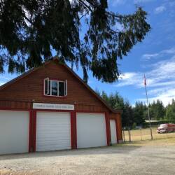 A red and white firehall stands against a backdrop of blue sky.