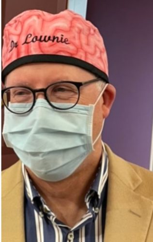 Photo of Dr. Stephen Lownie who is a neurosurgeon with Halifax's QEII Health Sciences Infirmary. He is wearing glasses and a face mask in the photo.