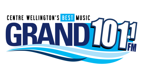 A blue and white logo that says "The Grand 101.1 FM"
