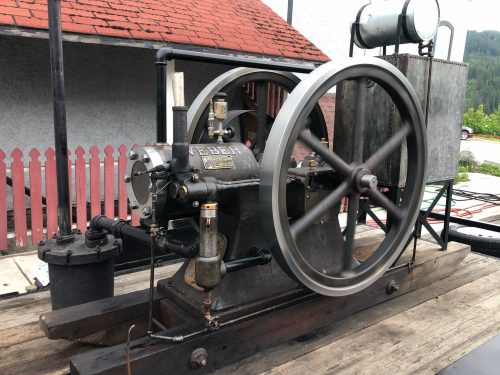An old engine on a wagon.