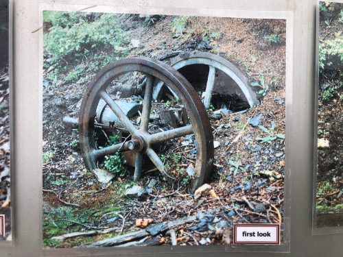 A photo of big wheels half buried in dirt.