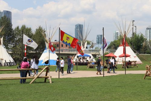 In the center of the circle of tipis, flags from all the Treaty 7 nations wave in the wind. Weather was clear.