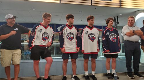 Hockey players wearing new team jerseys