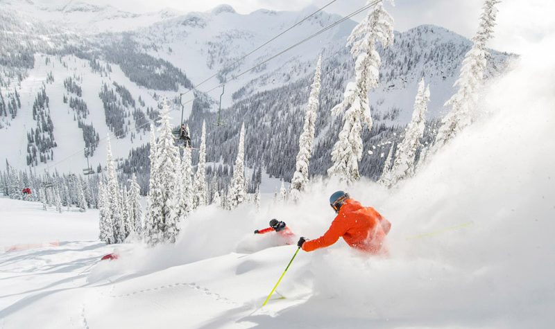 Two skiers enjoy some powder below Summit Chair
