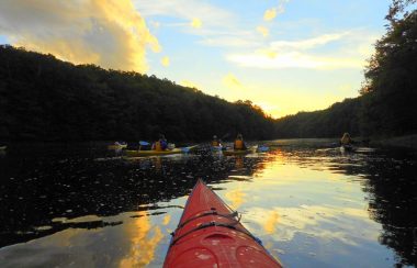 A kayak on a lake at sunset.