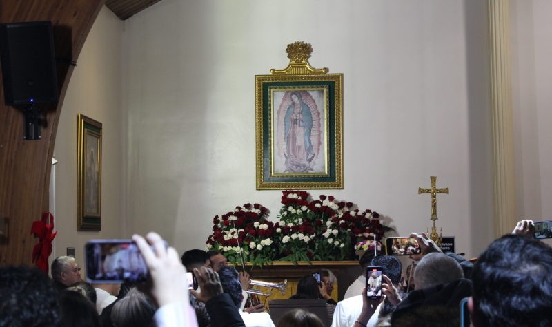 Fieles a la Virgen en la Misa de conmemoración frente a una imagen de la Virgen.
