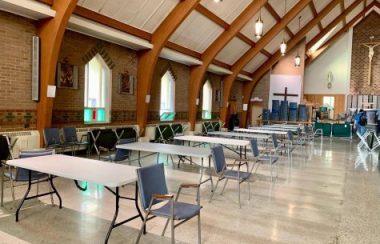 L'intérieur d'une église avec des tables et des chaises occupant tout l'espace.