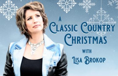 A poster for A Classic Country Christmas with Lisa Brokop standing in the foreground and a snowflake covered background.