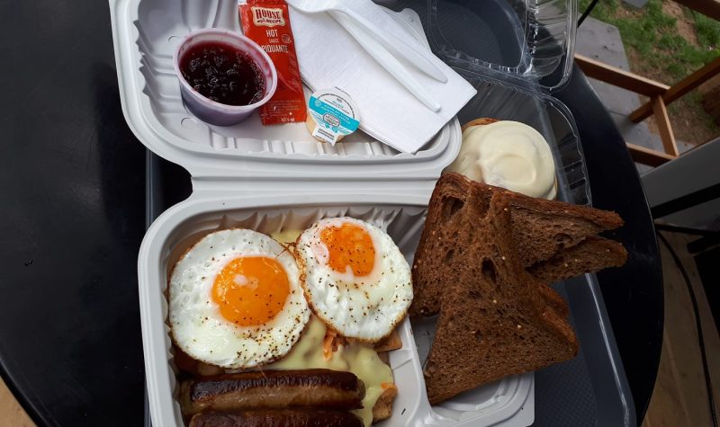 A to-go breakfast meal with eggs and toast.