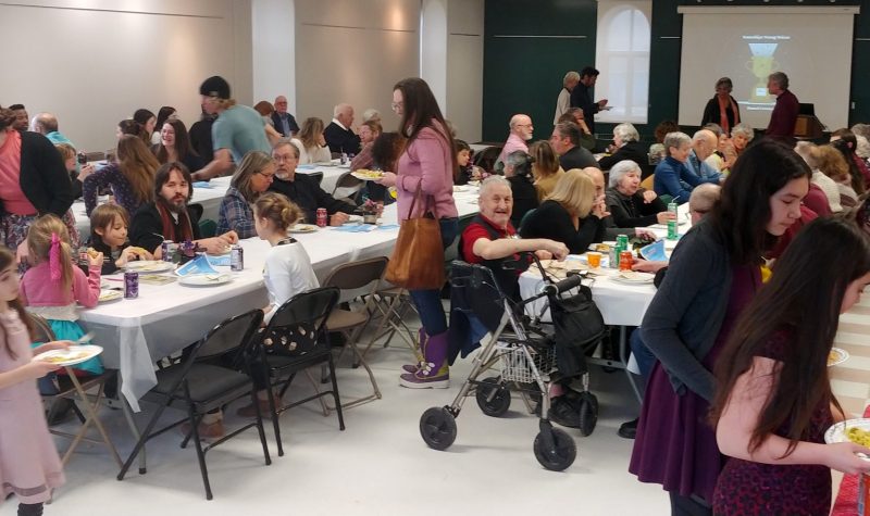 Pictured is the large crowd sitting down at their tables to eat the meal included for the event.