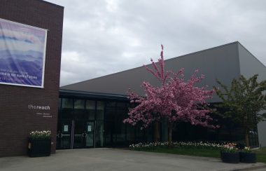 A photo of the outside of the reach gallery and museum. during springtime.