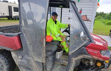 Bénévole vêtu d'un imperméable assis dans un côte-à-côte