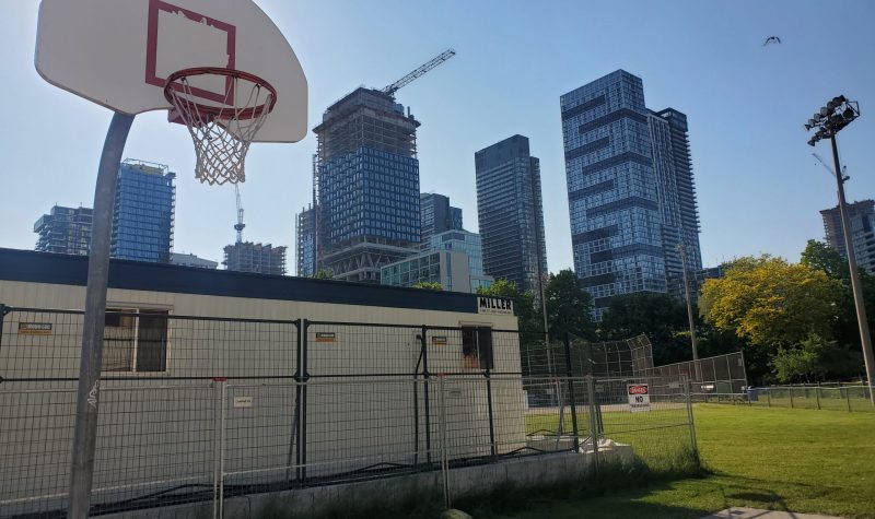 A basketball hoop with view of the Toronto skyline in background