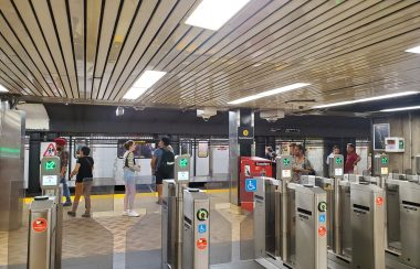 Dundas subway station. A train hasa arrived on the opposite platform and people are waiting.