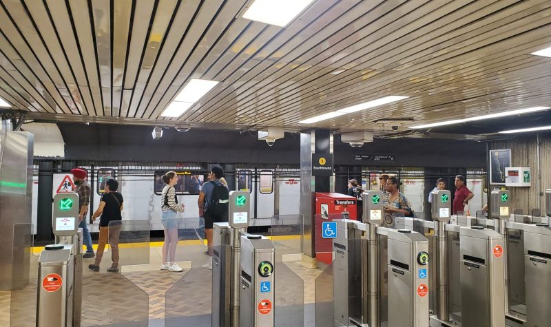 Dundas subway station. A train hasa arrived on the opposite platform and people are waiting.