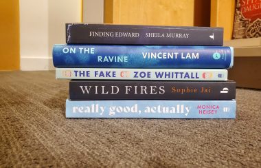 Five of the books on the longlist on the floor with stacked upon each other