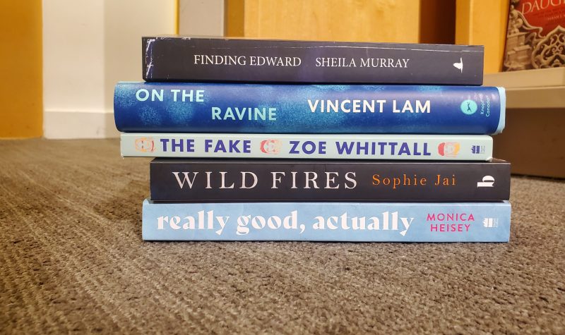 Five of the books on the longlist on the floor with stacked upon each other