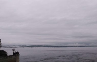 A foggy and cloudy day veils Vancouver Island from a ferry terminal.