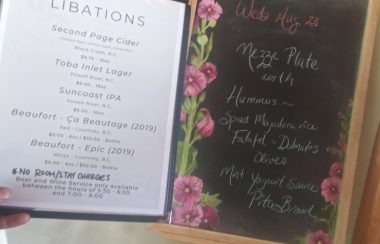 A ‘libations’ menu is displayed next to a lunch menu on an easel.