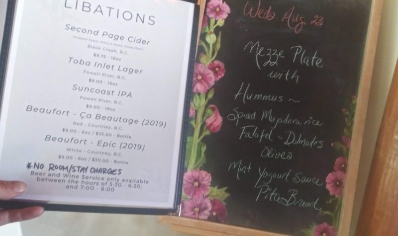 A ‘libations’ menu is displayed next to a lunch menu on an easel.
