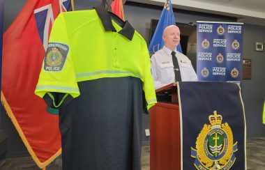 Chief Stuart Betts showing uniform of new property crime-focused unit.