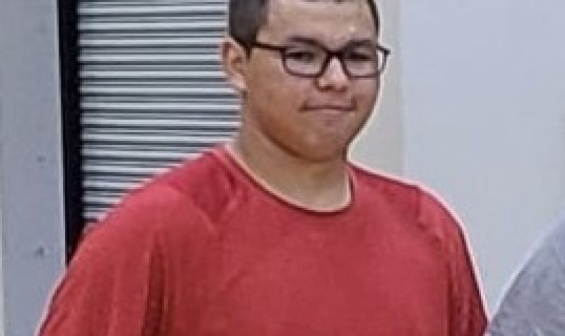 Young guys dressed in red shirt and wearing black rimmed glasses