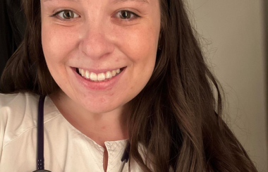 woman smiling with stethoscope around neck