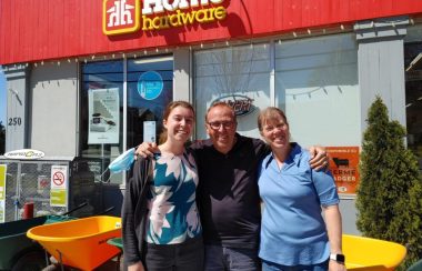 Picture from left to right is Catherine Barnes, Kevin Barnes, owner, and Chantal Barnes, owner, standing in front of their business sign.