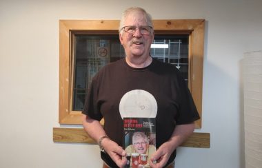 Pictured is Peter McAuslan holding his recently published book.