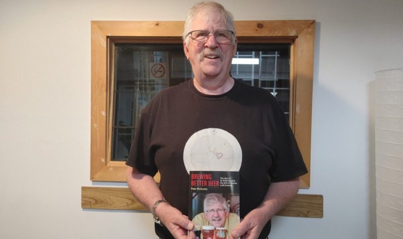 Pictured is Peter McAuslan holding his recently published book.