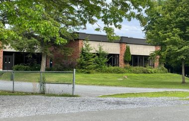 Pictured is part of the MVHS infrastructure. It is a brick building.