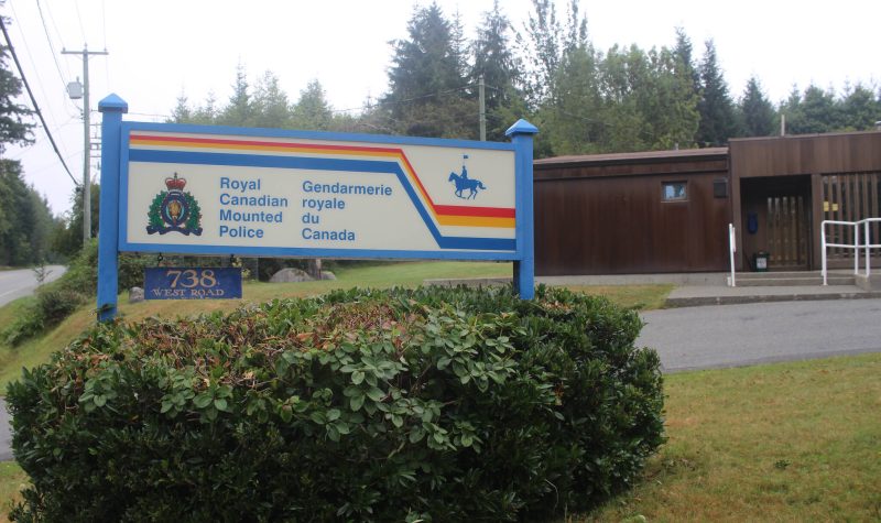 A sign marks the entrance to the Quadra Island RCMP detachment.