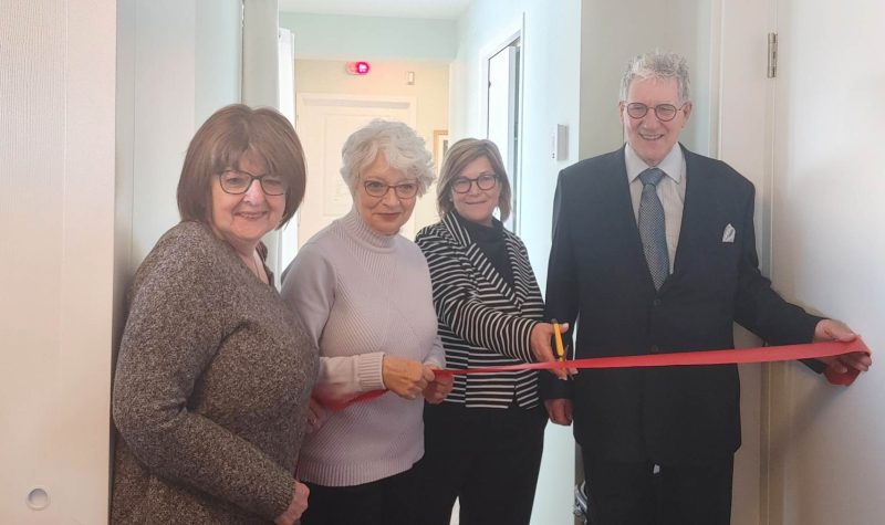 Four members that are involved in and/or have benefitted from the BMCSG's services officially cutting the ribbon to reveal the new spaces.