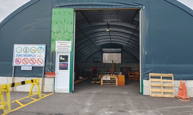 The front entrance to the reuse space. It is a dome-like structure with a large door. To the left of the entrance, there is the deposit station. It is identified using yellow blockers.